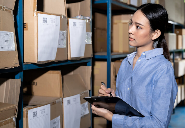 Woman working in a warehouse checking logistics